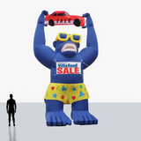 Custom 25 ft inflatable rooftop blue gorilla holding a car with glasses and shorts